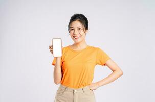 Portrait of cheerful happy Asian woman posing on white background photo