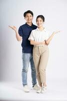 Image of an Asian couple posing on a white background photo