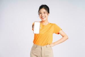 Portrait of cheerful happy Asian woman posing on white background photo