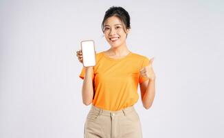 Portrait of cheerful happy Asian woman posing on white background photo