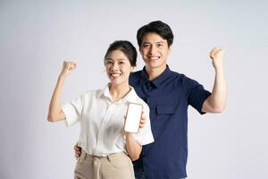 Image of an Asian couple posing on a white background photo