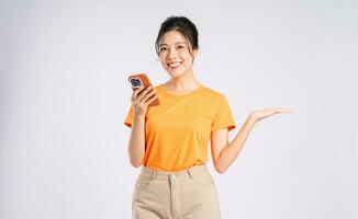 Portrait of cheerful happy Asian woman posing on white background photo