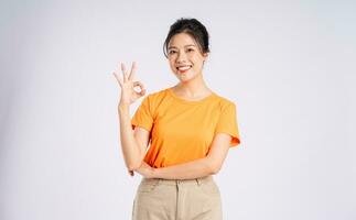 Portrait of cheerful happy Asian woman posing on white background photo