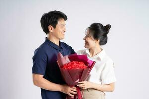 Image of an Asian couple posing on a white background photo