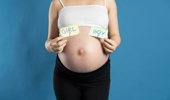 Portrait of pregnant asian woman, isolated on blue background photo