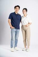 Image of an Asian couple posing on a white background photo