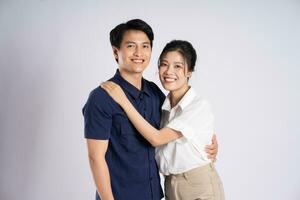 Image of an Asian couple posing on a white background photo