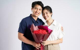 Image of an Asian couple posing on a white background photo