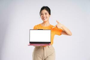 Portrait of cheerful happy Asian woman posing on white background photo