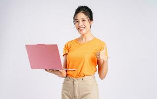 Portrait of cheerful happy Asian woman posing on white background photo