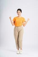 Portrait of cheerful happy Asian woman posing on white background photo