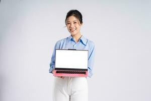 Portrait of young Asian businesswoman, isolated on white background photo