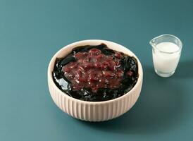 Red Bean Panna Cotta served in bowl isolated on background top view of taiwan food photo