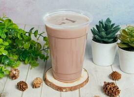 Ovaltine Latte served om disposable glass isolated on wooden board top view of hong kong drink photo