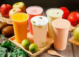 Assorted fresh juices watermelon juice, Kumquat Lemon, papaya milk, mango juice, Avocado Pudding Milk served in glass isolated on table top view of morning vitamins drink photo