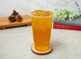 Osmanthus Oolong ice Tea served in disposable glass isolated on background top view of taiwan drink photo