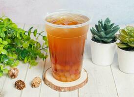 Winter Melon Rainbow Beads Ice Tea served on disposable glass isolated on wooden board top view of hong kong drink photo