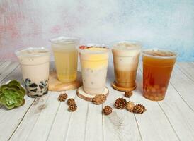 lemon ice tea or lemonade, pudding taro milk, Special iced Latte, Winter Melon Rainbow Beads, Brown Sugar Creamy Milk with bubbles, served om disposable glass isolated top view of hong kong drink photo