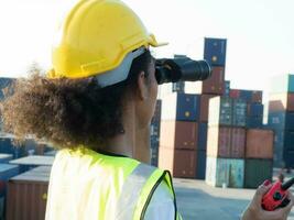 Female  woman lady man male person people human binocular talk speak discussion talkie walkie radio holding talkie walkie import export container yellow hardhat safety technology industry labor  work photo