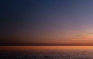 Sunset Sky,Cloud over Sea Beach in Evening on Spring,Landscape by Seaside with Colourful Sky in Orange,Pink,Purple,Blue.Horizon Summer Seascape Golden hour sky with twilight,Dusk sky background photo