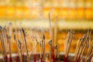 Closeup a incense burned to worship  Buddha in a pot and on blurry background. photo