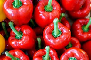 Closeup and crop heap of red bell pepper fit on screen background and wallpaper. photo