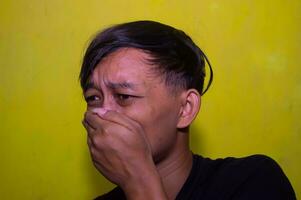 Gresik, Indonesia, December 5 2023 - The expression of a young man with a slight smile photo