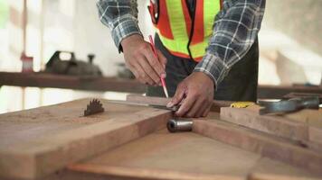 Carpenter young working on woodworking machines in carpentry shop. Asia man works in a carpentry shop. video