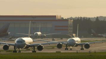 Airplanes backlit on the airfield video