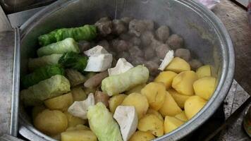 Siomay sellers serve buyers in plastic containers. Siomay is a typical Indonesian snack made from a mixture of wheat flour and fish or chicken meat combined with peanut sauce. video