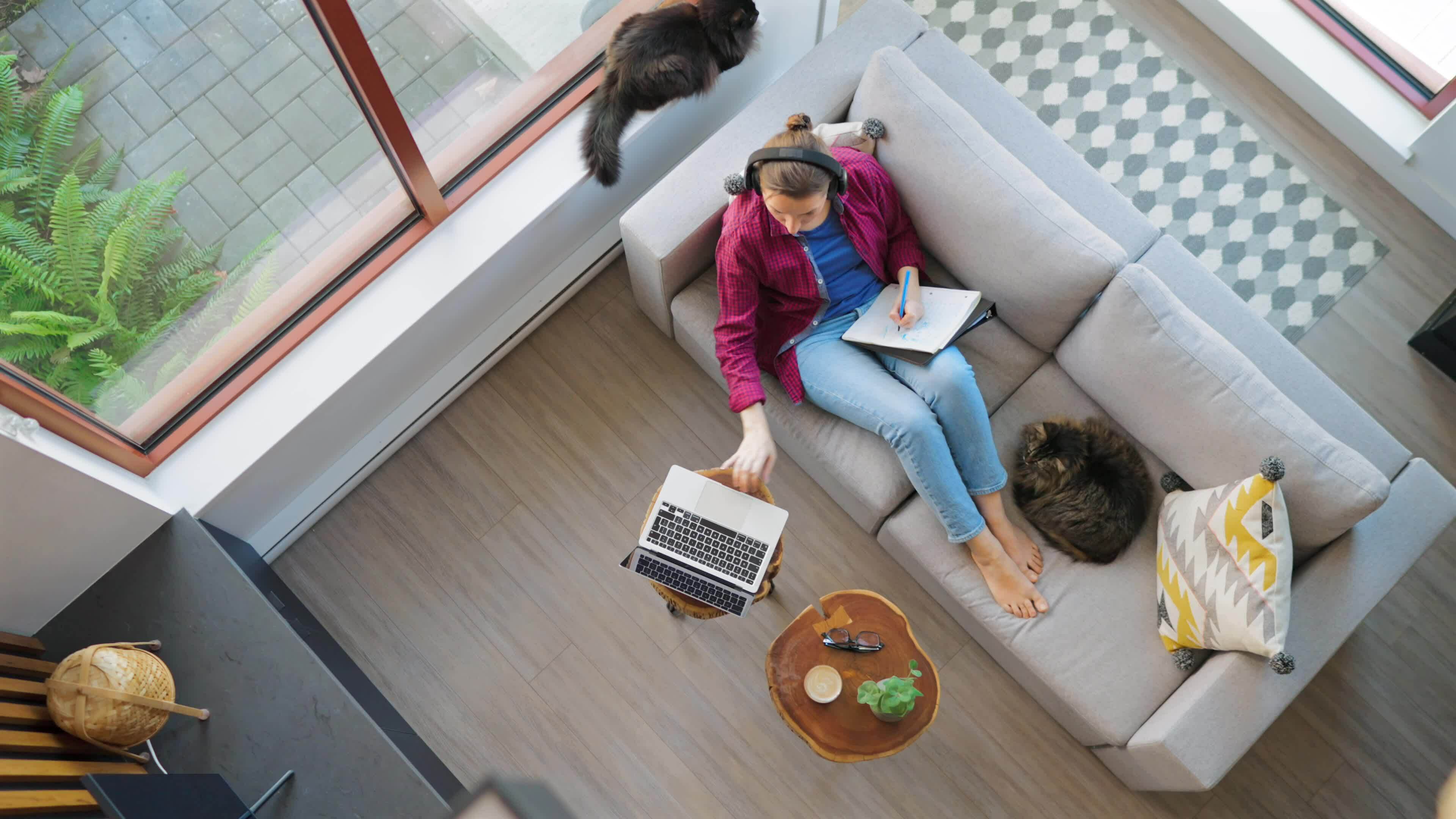 Overhead view of woman writing notes, lying on couch at home 36495776 ...