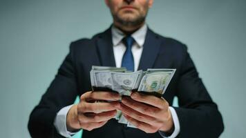 Formally dressed man counting US Dollar bills, close-up. video