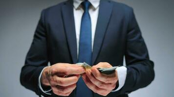 Formally dressed man counting US Dollar bills, close-up. video