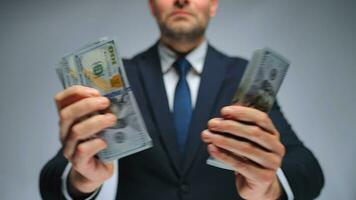 Formally dressed man counting US Dollar bills, close-up. video