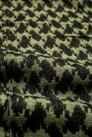 Keffieh scarf. The texture of the cotton traditional symbolic arabian scarf. Khaki back. photo