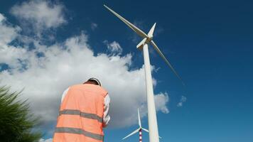 Architect is verifying the suitability of the wind turbines by drone video