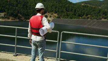 Use a helmet for safety at work near the new dam construction video