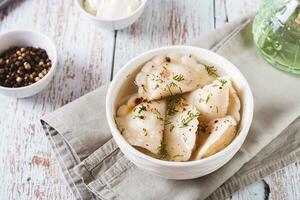 Soup with dumplings, herbs, spices and sour cream in a bowl on the table photo