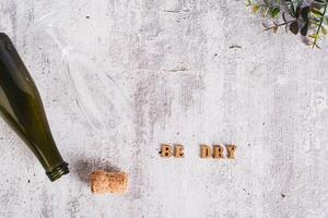 Sober January concept, text, glass, bottle and cork on the table top view photo