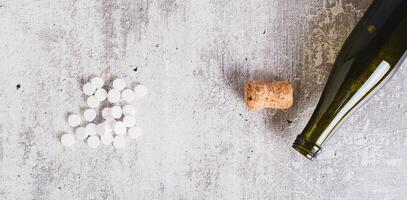 Sobriety concept, alcoholism pills, empty bottle and cork on table top view web banner photo