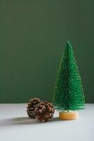 Christmas decorative spruce and pine cones on a green background vertical view photo