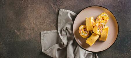 Tortilla rolls with salad of sausages, eggs, cheese and herbs on a plate top view web banner photo