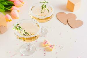 Refreshing mocktails in glasses and candy hearts on a plate for valentine's day photo