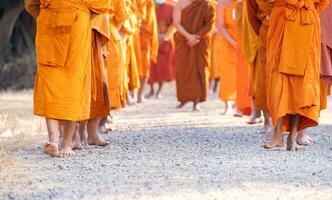 Monks walking for meditation, practicing religious physical exercises, performing religious ceremonies, dressing, praying. photo