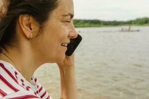 Portrait of a middle-aged woman talking on a mobile phone photo