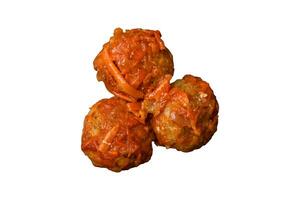 Delicious fresh meatballs from minced meat or fish with tomato sauce photo