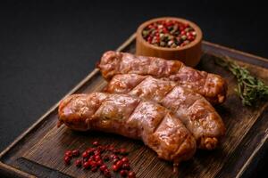 Delicious juicy grilled chicken or pork sausages with salt, spices and herbs photo