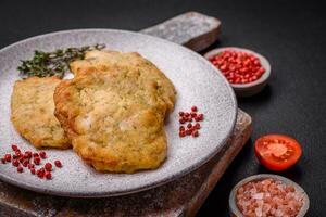 Delicious juicy fried chicken or pork pancakes with salt, spices and herbs photo