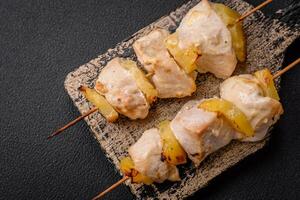 Delicious chicken or turkey kebab with pineapple pieces on skewers photo