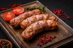 Delicious juicy grilled chicken or pork sausages with salt, spices and herbs photo